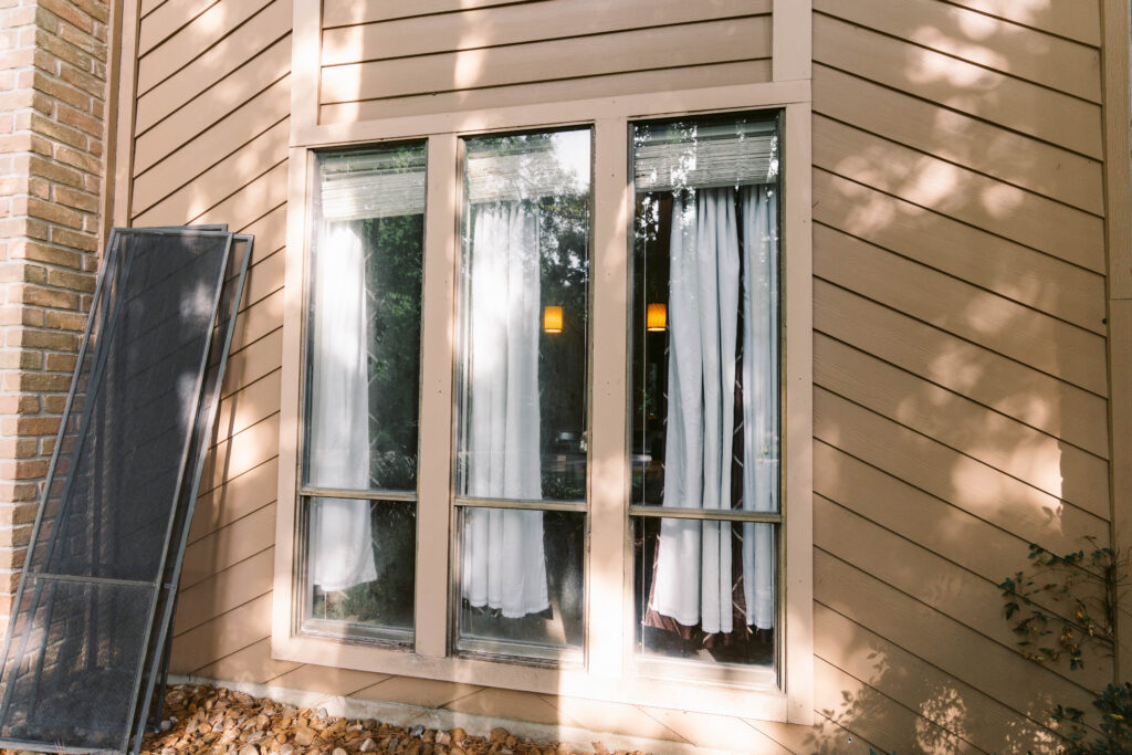 Exterior view of dirty three panel windows before professional cleaning in Houston, TX