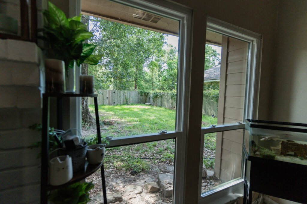 Residential living room windows before professional window cleaning in Houston, TX.