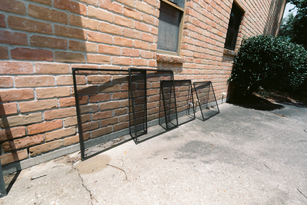 Residential window screens prepared for professional cleaning in Houston, TX