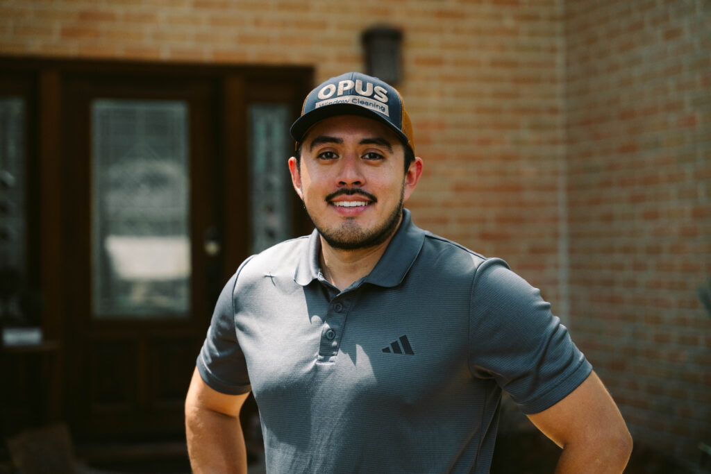 Window cleaning company owner standing outside a customer's home in Houston, TX